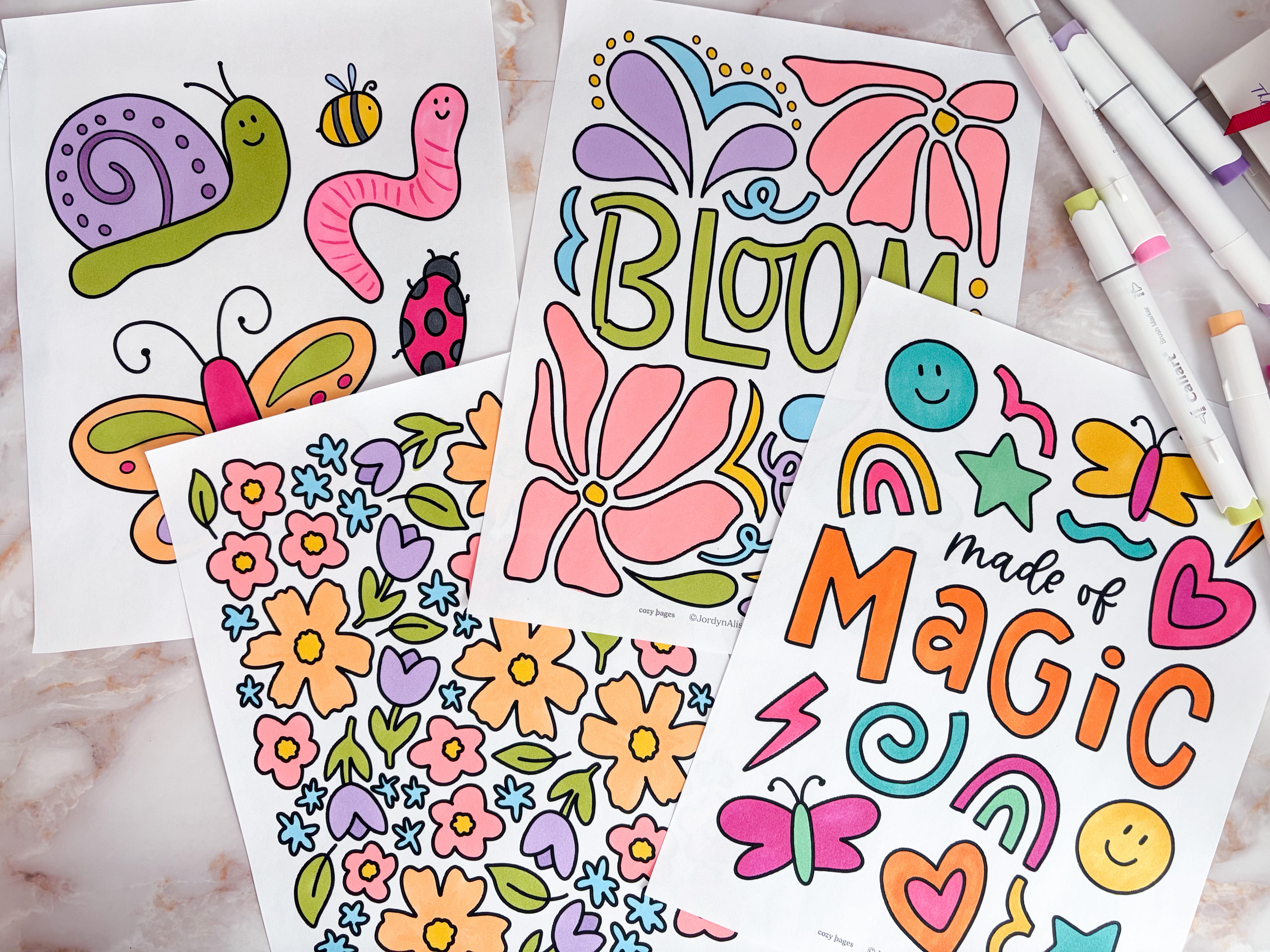 Brightly colored coloring pages with alcohol markers.