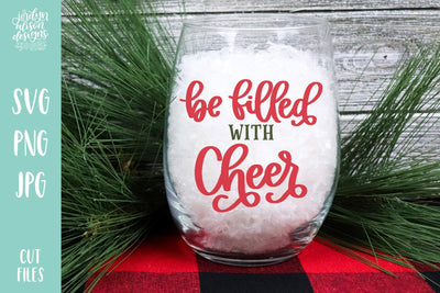 Glass filled with white snow, handwritten text on glass "be filled with Cheer"