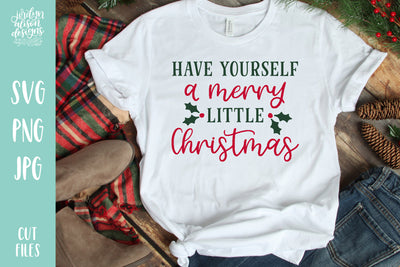 White T-shirt with handwritten text "Have Yourself a Merry Little Christmas"