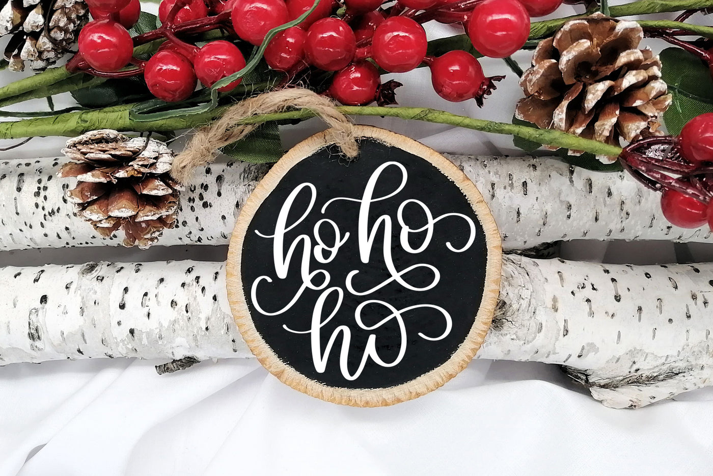 Handwritten text "Ho Ho Ho" on Round Christmas Ornament. 